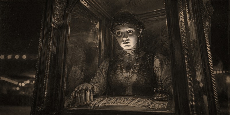 A mechanical fortune-teller automaton in a glass booth